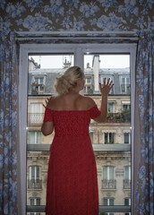 Woman looking out of window, Paris