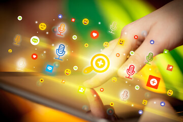 Close-up of a hand using tablet with social media icons