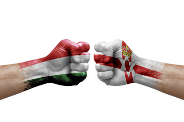 Two hands punch to each others on white background. Country flags painted fists, conflict crisis concept between hungary and ireland