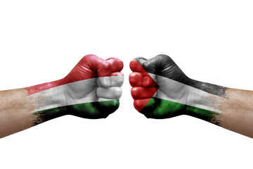 Two hands punch to each others on white background. Country flags painted fists, conflict crisis concept between hungary and palestine
