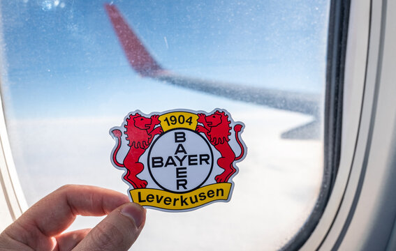 December 6, 2021. Leverkusen, Germany. The emblem of the Bayer 04 Leverkusen football club on the background of an airplane window.