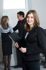 Fototapeta na wymiar Smiling young businesswoman in office
