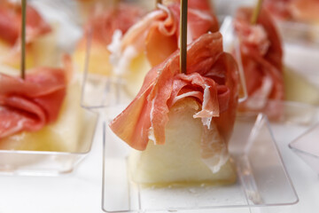 Canapes with jamon and juicy pineapple.