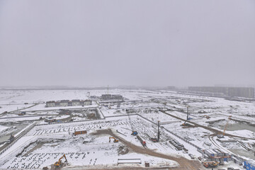 Fototapeta na wymiar View from the window at the construction site in winter 