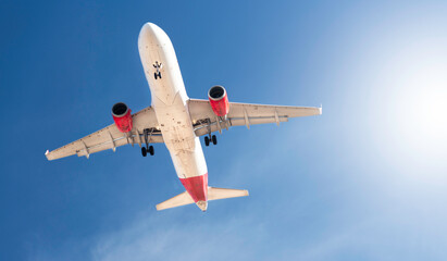 plane flying over blue sky background - travel concept.