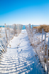 Snow fences on the beach. Beach access at the Atlantic Ocean on Cape Cod. 