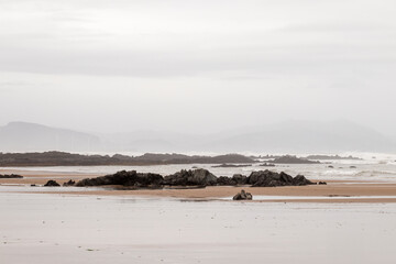 Fototapeta na wymiar rocks on the beach of sopelana a cloudy winter day