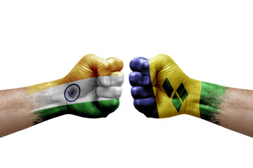 Two hands punch to each others on white background. Country flags painted fists, conflict crisis concept between india and saint vincent and the grenadines