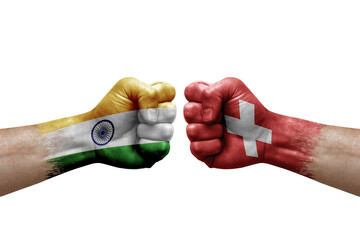 Two hands punch to each others on white background. Country flags painted fists, conflict crisis concept between india and switzerland