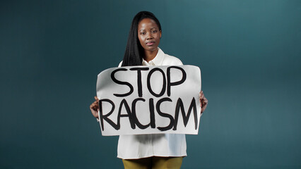 Beautiful Black girl holding a protest placard Stop racism
