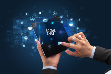 Businessman holding a foldable smartphone, social media concept