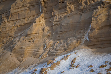 Beautiful layered formation of sand with snow close-up