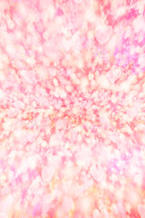 キラキラとハートが飛び交うピンク色の華やかな背景　縦