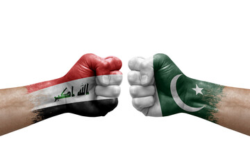 Two hands punch to each others on white background. Country flags painted fists, conflict crisis concept between iraq and pakistan