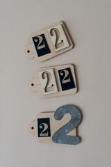 the number 2 or 22 on unpainted wooden tags or labels on paper