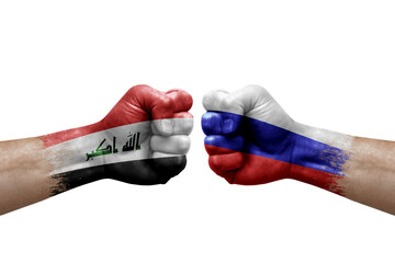 Two hands punch to each others on white background. Country flags painted fists, conflict crisis concept between iraq and russia