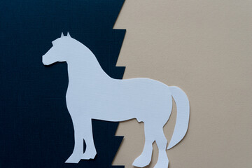 paper horse on a paper background with a serrated edge