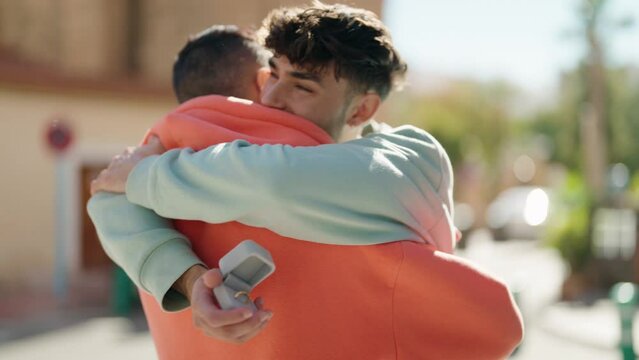 Young hispanic couple smiling confident having marriage proposal at street