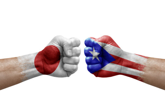 Two hands punch to each others on white background. Country flags painted fists, conflict crisis concept between japan and puerto rico
