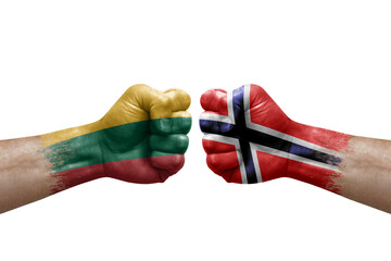 Two hands punch to each others on white background. Country flags painted fists, conflict crisis concept between lithuania and norway