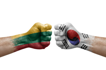 Two hands punch to each others on white background. Country flags painted fists, conflict crisis concept between lithuania and south korea