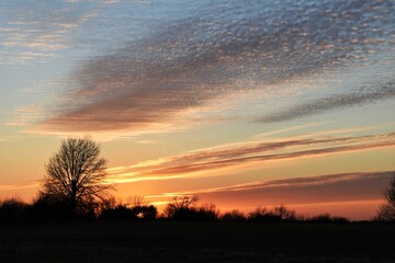 Fototapeta na wymiar Dramatic Sunset Over a Field