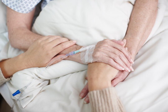 Comforting a sick family member. Cropped image of an affectionate daughters hand being held by her mother in the hospital.