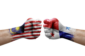 Two hands punch to each others on white background. Country flags painted fists, conflict crisis concept between malaysia and panama
