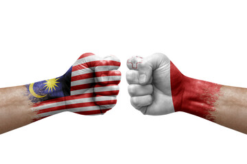 Two hands punch to each others on white background. Country flags painted fists, conflict crisis concept between malaysia and malta