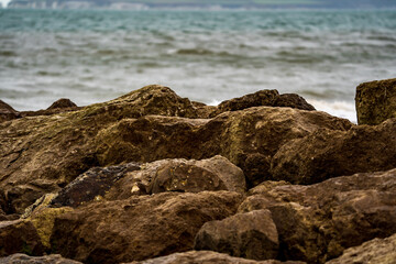 Rock groynes with waves in the background