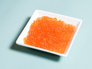Salmon roes isolated or salmon caviars on a plate, Seafood background	