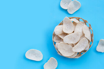 Prawn crackers on blue background. Shrimp crispy rice snack