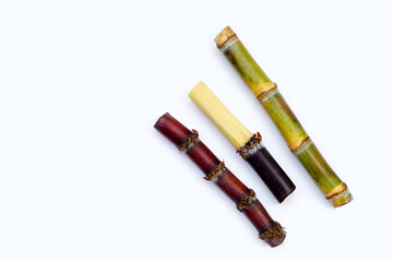 Sugar cane with brown sugar on white background