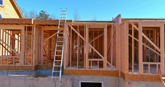 Exterior view of a new house under construction framing the beams stick