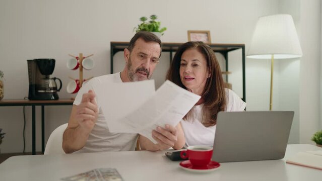 Man and woman couple using laptop teleworking at home