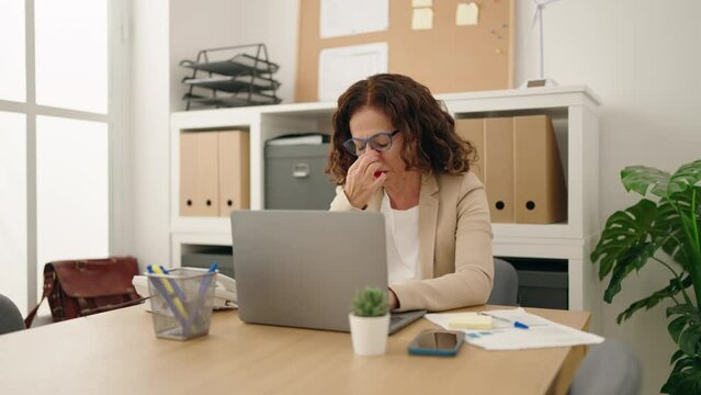Middle age woman business worker stressed working at office