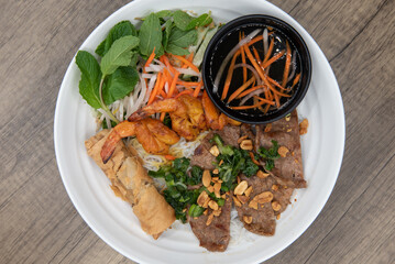 Overhead view of grilled chicken with iverted rice for a Vietnamese meal served with tradional dressing sauce