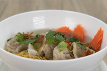 Hearty wonton noodles soup, served with hot broth, for a delicious Vietnamese meal