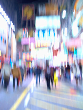 Motion blurred city life. Motion and lens blurred photo of city people.