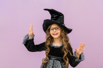 A cheerful witch is happy about the upcoming Halloween holiday.