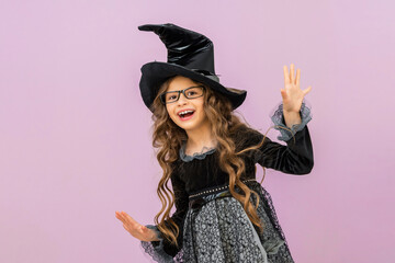 A cheerful witch is happy about the upcoming Halloween holiday.