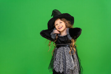 The child is ready for the heluin holiday. A girl in a witch's magic hat.