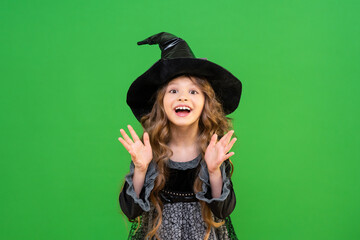 The child is ready for the heluin holiday. A girl in a witch's magic hat.