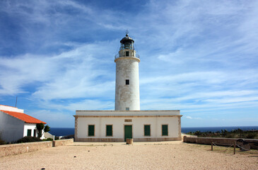 famous lighthouse of the mola on a coast of formentera seen from the front