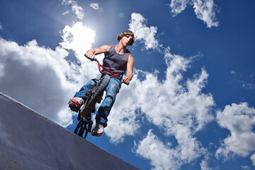 Practicing for the x games. Full length shot of a teenage boy riding a BMX at a skatepark.