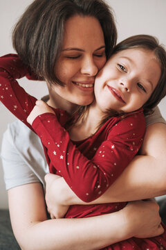Close up portrait of hugging family happy Mom and daughter together at the home