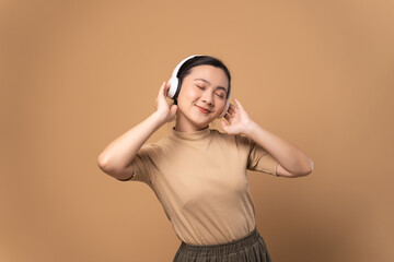Happy woman with headphones and listening to music.