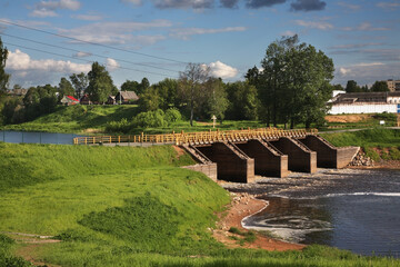 Fototapeta premium Dam of Tikhvinsky lock at Tikhvinka river in Tikhvin. Leningrad oblast. Russia