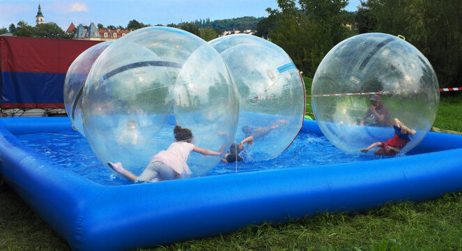 Fun for children, a plastic balloon filled with air on the water, zorbing ...