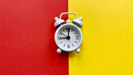 Alarm clocks on red and yellow background. Copy Space concept